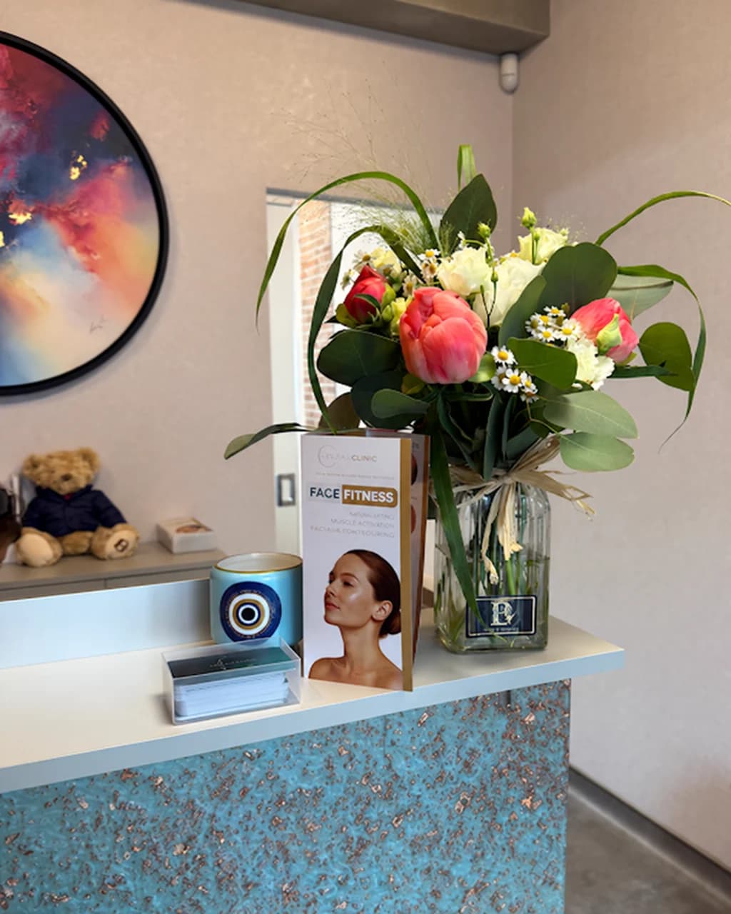 Reception desk at Levitas Clinic Esher with a vase of flowers