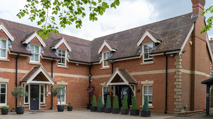 Red-brick Levitas Clinic building in Guildford with gabled entrance porches